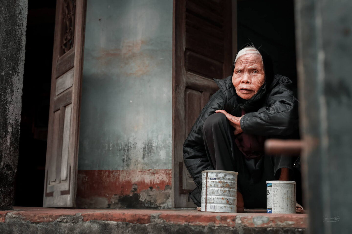 A woman rests on the porch of her house in Duong Lam ancient village near Hanoi.