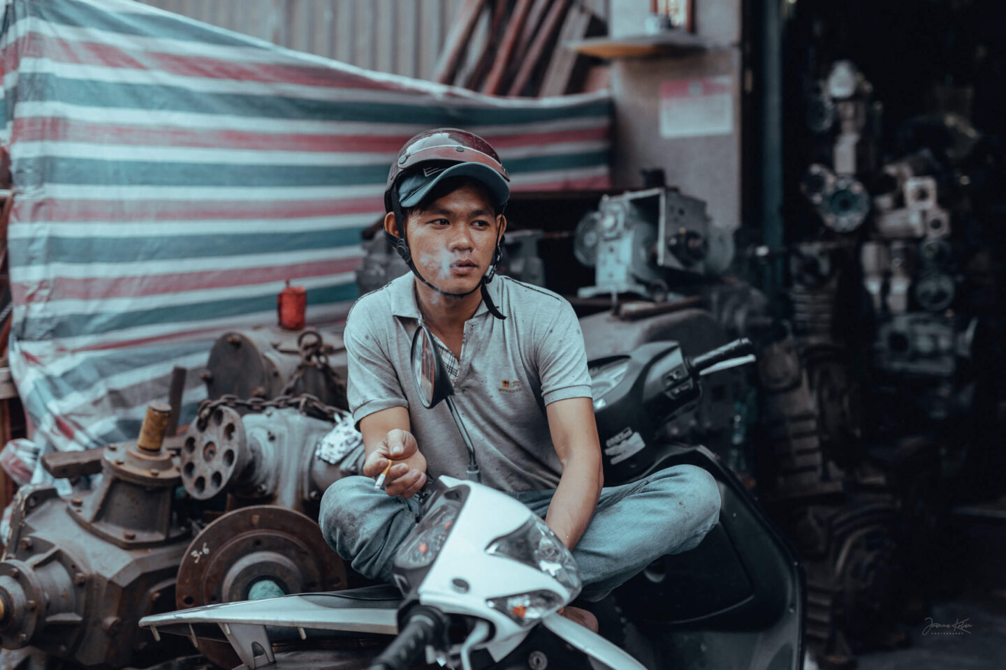 A man takes a break from work in front of a steel workshop in the Cho Lon district of Ho Chi Minh city, Southeast Vietnam. 