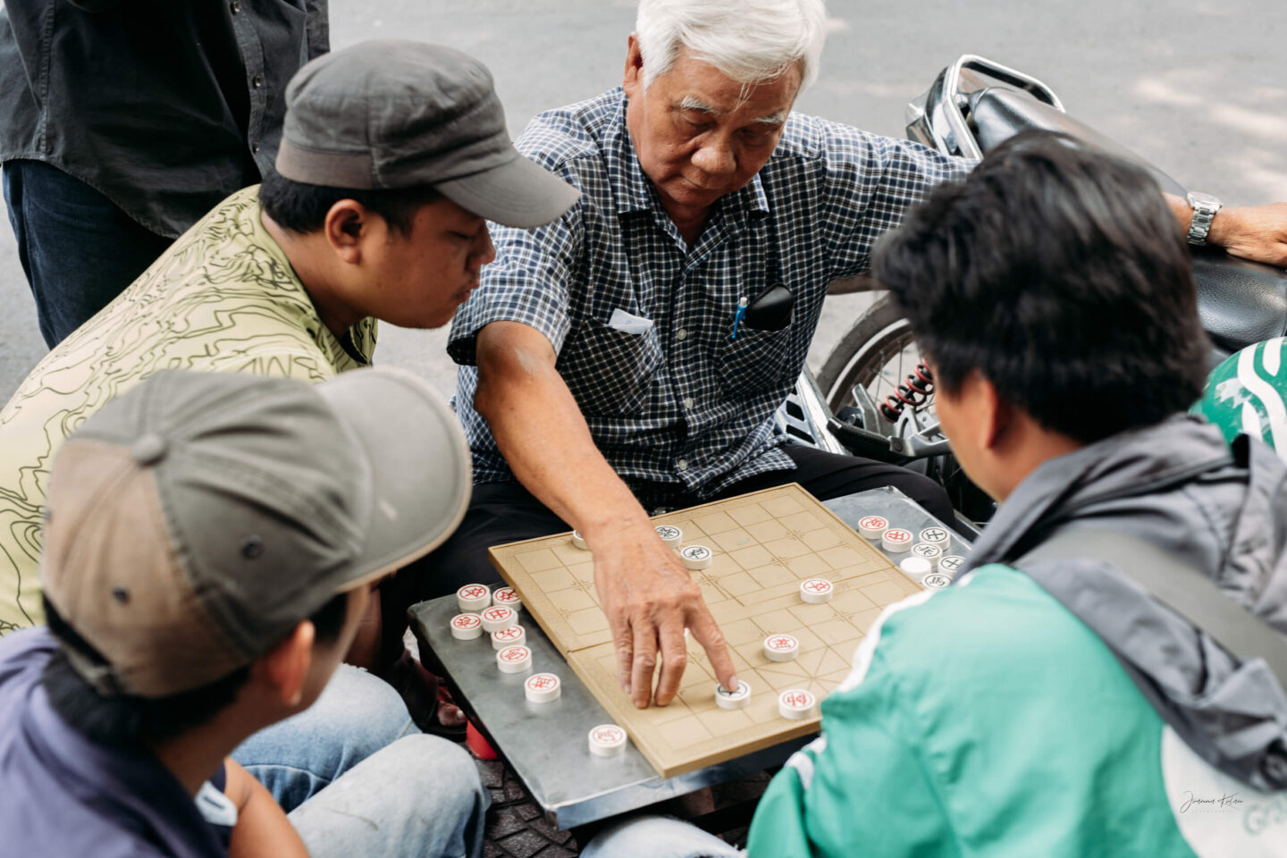 Men play Xiangqi, also called Chinese Chess or elephant chess, in the streets of Ho Chi Minh City, Southeast Vietnam.