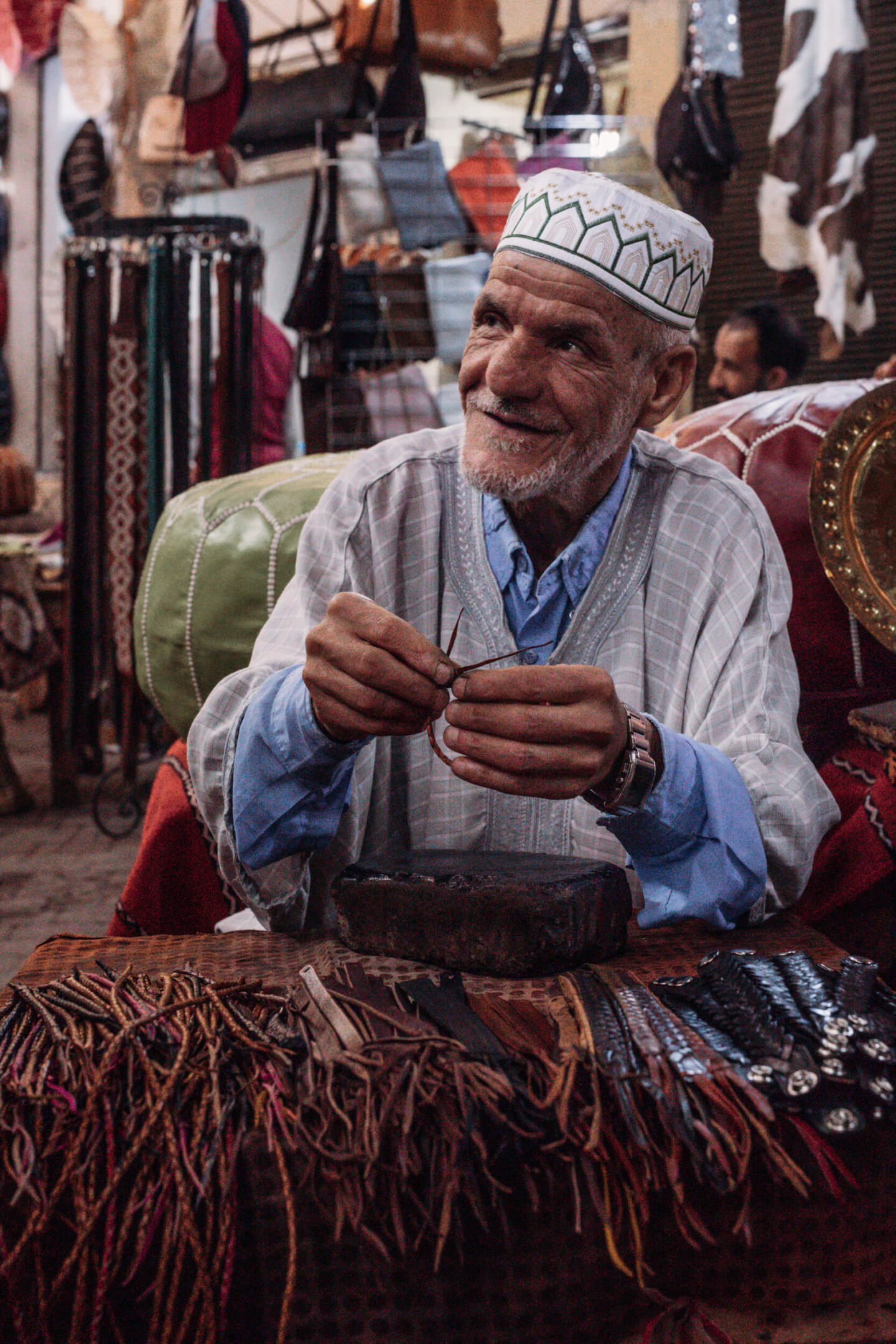 An artisan working with leather at work in the Medina of Marrakech 